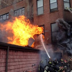 Boston firefighters react as fire conditions rapidly change at the March 26, 2014 fire that claimed Lt. Edward Walsh and firefighter Michael Kennedy.
