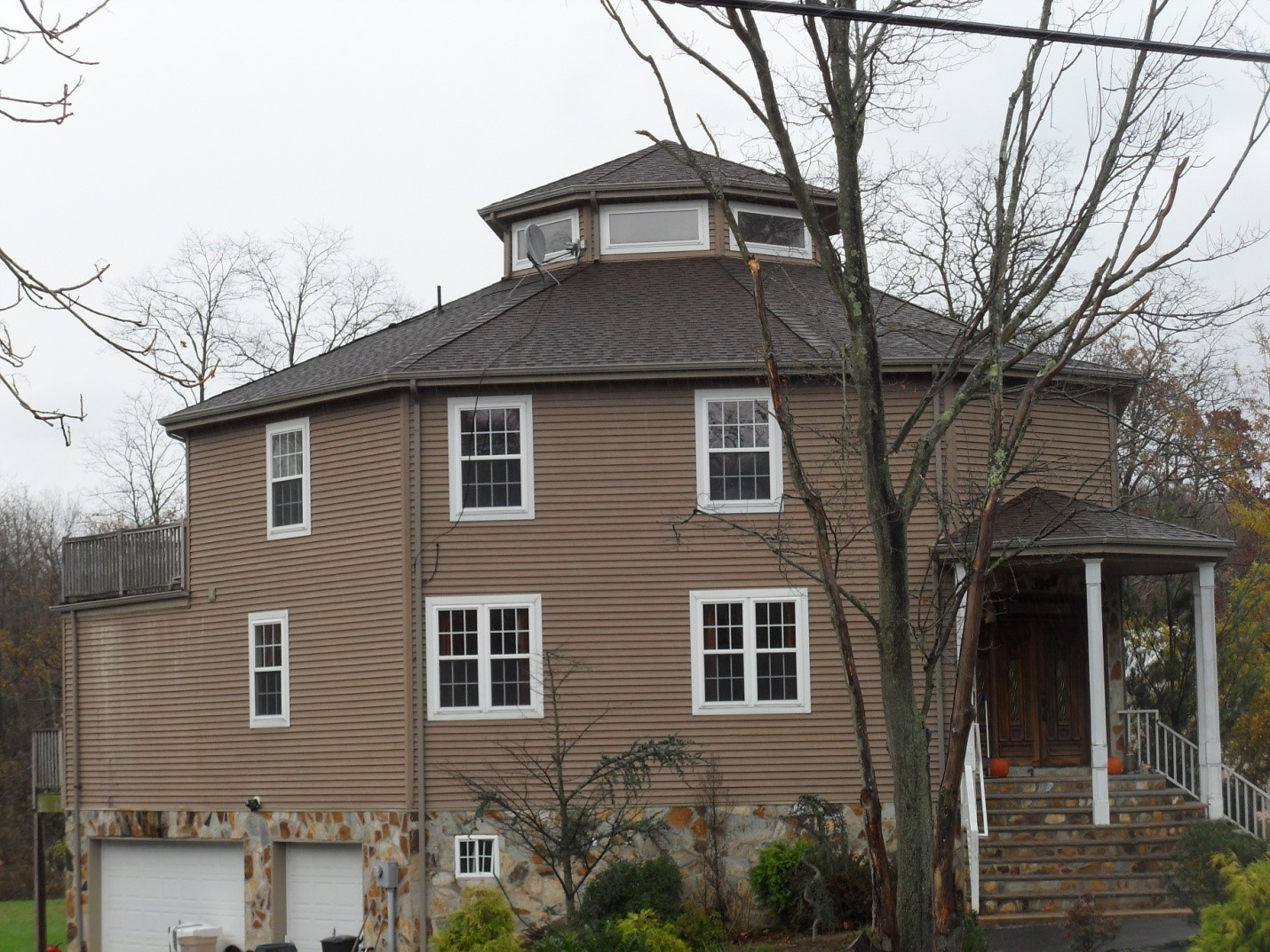 Photo 6: Consider using existing openings to start vertical ventilation operations. Clearing the windows from this roof would be much faster than cutting the roofing materials.