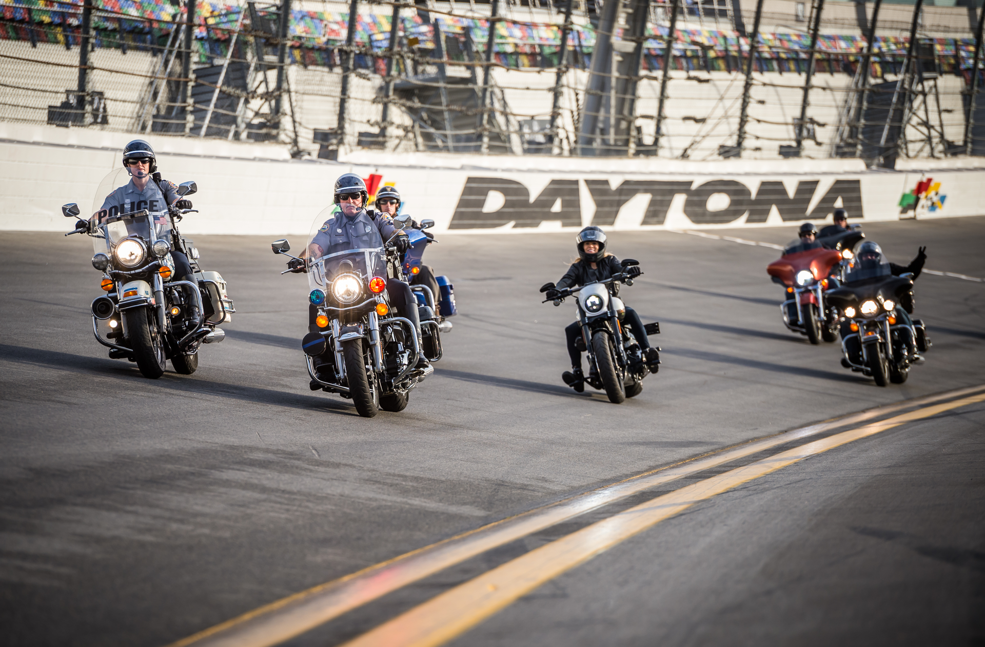 Karen Davidson, great-granddaughter of the company co-founder, riding a 2016 CVO Pro Street Breakout, leads a group military personnel and first responders on an honorary lap around Daytona International Speedway.