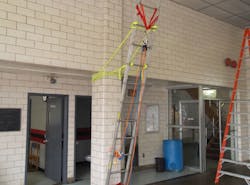 Photo 4: Crews can use ropes to practice moving tools or rope rescue skills. During this drill, members constructed a ladder gantry off one of the columns in the firehouse. This was used as a change of direction to lift a packaged patient off the floor.