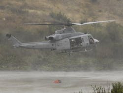 A Marine UH-1Y Venom fills up its Bambi Bucket from Lake Pulgas. A Marine UH-1Y Venom fills up its Bambi Bucket from Lake Pulgas.