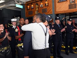 Arif Wedderburn hugs firefighter Erik Wiener during their reunion. Arif Wedderburn hugs firefighter Erik Wiener during their reunion.