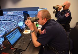 Battalion Chief Gerald Randall and firefighter Danny Martin use binoculars to assess a report of a person with a head injury on the floor. Battalion Chief Gerald Randall and firefighter Danny Martin use binoculars to assess a report of a person with a head injury on the floor.