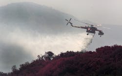 A helicopter drops water, aiding ground crews at Rancho La Scherpa, a mountain top retreat center, while working the Sherpa Fire in Santa Barbara County, Calif., on Friday, June 17, 2016. A helicopter drops water, aiding ground crews at Rancho La Scherpa, a mountain top retreat center, while working the Sherpa Fire in Santa Barbara County, Calif., on Friday, June 17, 2016.