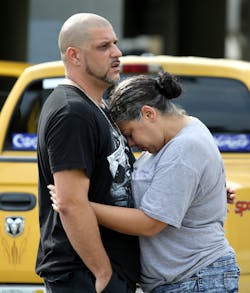 Ray Rivera, DJ at the Pulse nightclub, is consoled by a friend outside of the Orlando Police Department on Sunday, June 12, 2016.