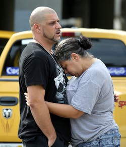 Ray Rivera, DJ at the Pulse nightclub, is consoled by a friend outside of the Orlando Police Department on Sunday, June 12, 2016. Ray Rivera, DJ at the Pulse nightclub, is consoled by a friend outside of the Orlando Police Department on Sunday, June 12, 2016.