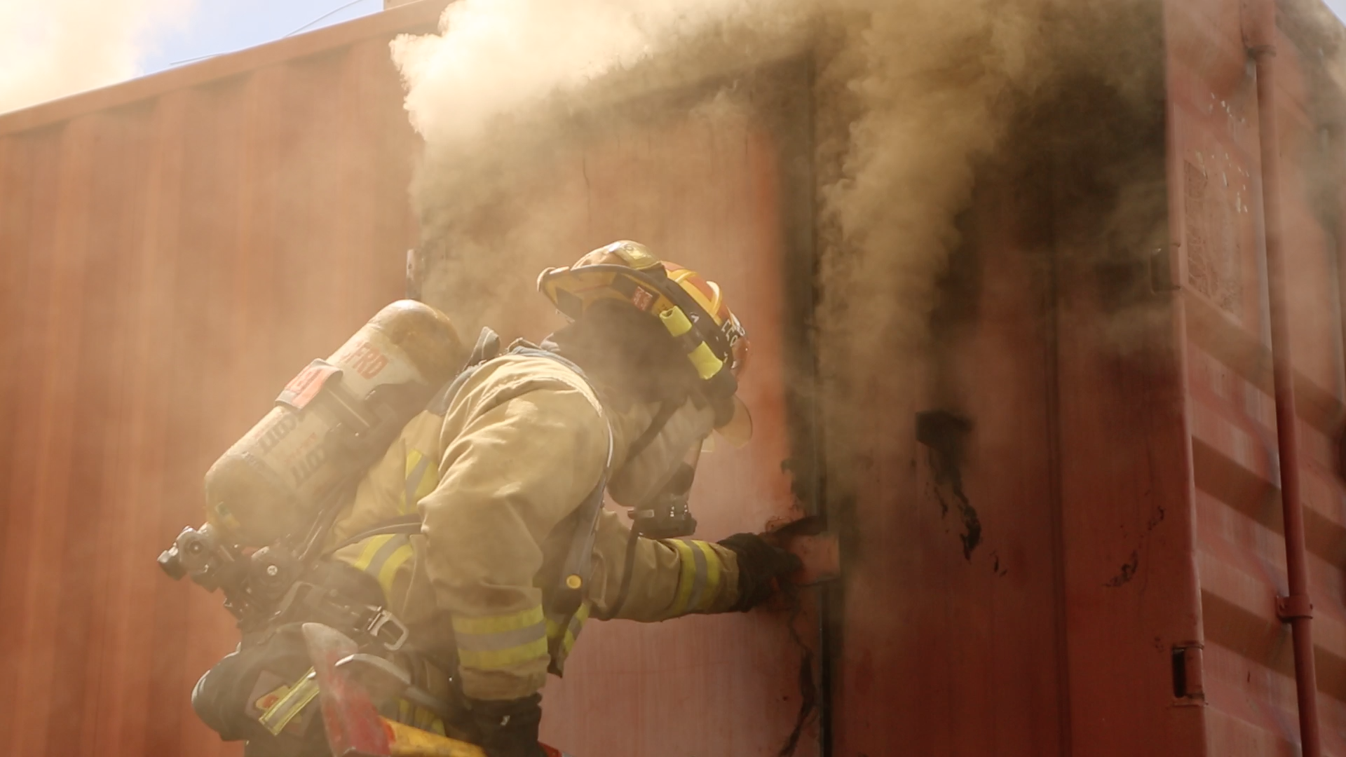 The firefighter in charge of door control in preparation for entry and egress for interior attack crews during live fire training.