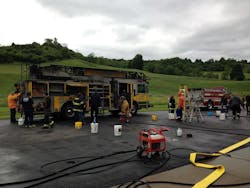 Firefighters from neighboring communities help Poland firefighters clean soot from their apparatus following a fire at their station. Firefighters from neighboring communities help Poland firefighters clean soot from their apparatus following a fire at their station.