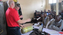 Fishers, IN, Fire Department Fire Captain Todd Rielage and Cincinnati Fire Captain Matt Flagler begin a classroom session on SCBA during the Africa Fire Mission training in Nairobi, Kenya. Fishers, IN, Fire Department Fire Captain Todd Rielage and Cincinnati Fire Captain Matt Flagler begin a classroom session on SCBA during the Africa Fire Mission training in Nairobi, Kenya.