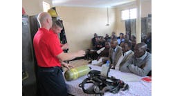 Fishers, IN, Fire Department Fire Captain Todd Rielage and Cincinnati Fire Captain Matt Flagler begin a classroom session on SCBA during the Africa Fire Mission training in Nairobi, Kenya.
