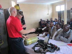 Fishers, IN, Fire Department Fire Captain Todd Rielage and Cincinnati Fire Captain Matt Flagler begin a classroom session on SCBA during the Africa Fire Mission training in Nairobi, Kenya.