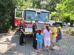 It is important for firefighters to talk with the public at a community event, not simply leaning on the bumper, but engaging with them and answering questions.