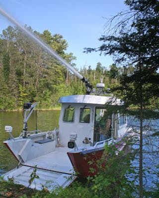 A 33-foot Lake Assault fireboat, owned and operated by the Lake Vermilion Fire Brigade, provided support for wildland firefighting efforts during the Foss Lake wildfire near Ely, Minn. earlier this spring. The 33-foot craft was used to haul up to 20-person crews, and their canoes and equipment to staging areas to fight the blaze.