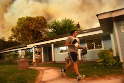 Seth Moberg, 16, gathers belongings from his family&apos;s house as the Sand fire approaches in Santa Clarita, Calif., on Saturday, July 23, 2016.
