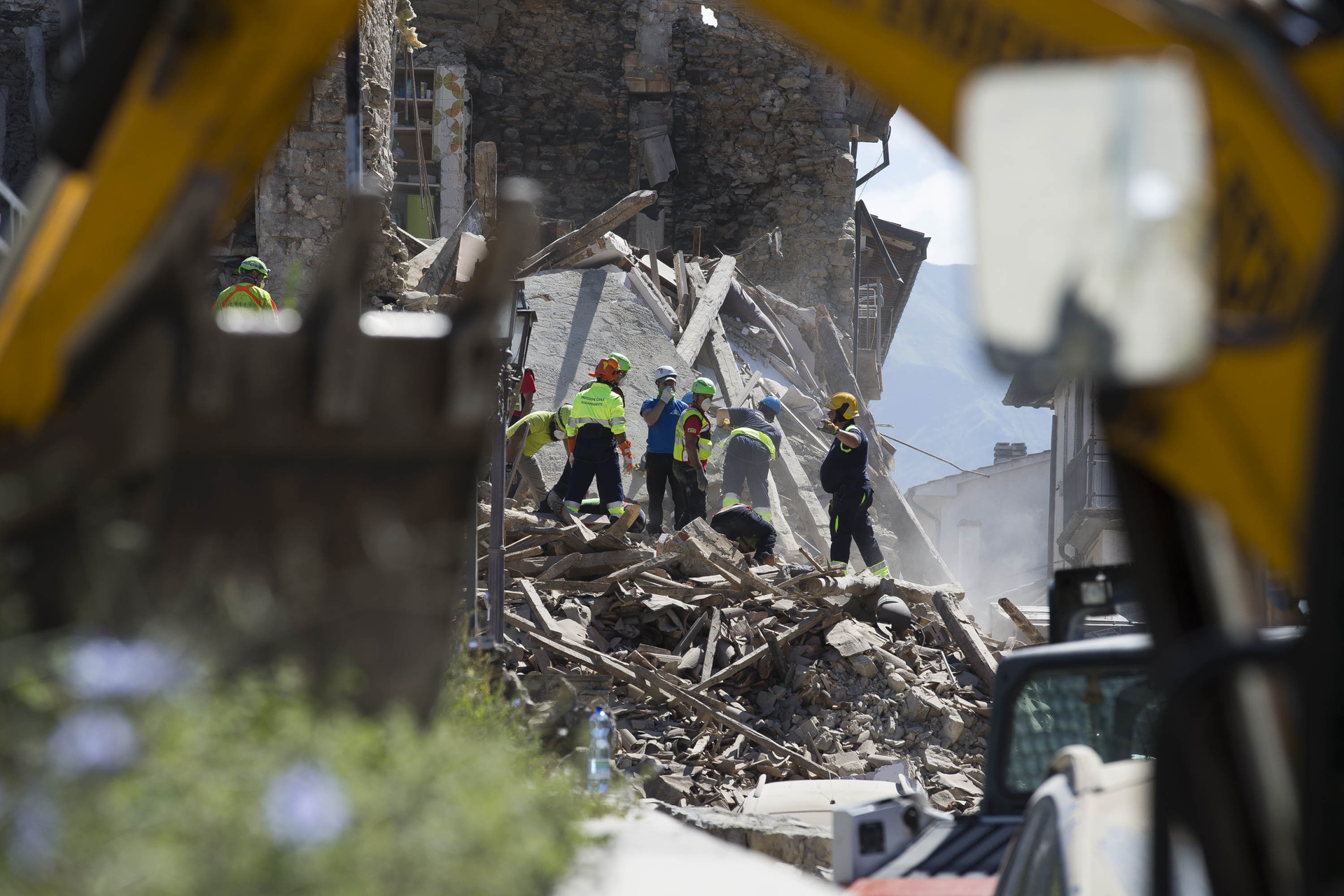 Italian rescue personnel search for victims.