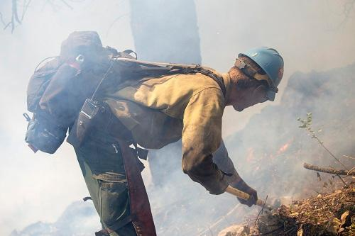Heat is taking toll on firefighters like this one at work in Boise.