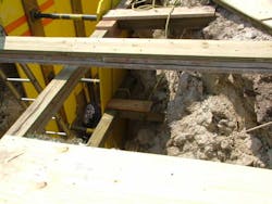 Photo 2: This collapse resulted in a catastrophic failure of a side wall that needed outside Walers and supplemental shoring to direct the forces back into the soil, both horizontally and vertically.