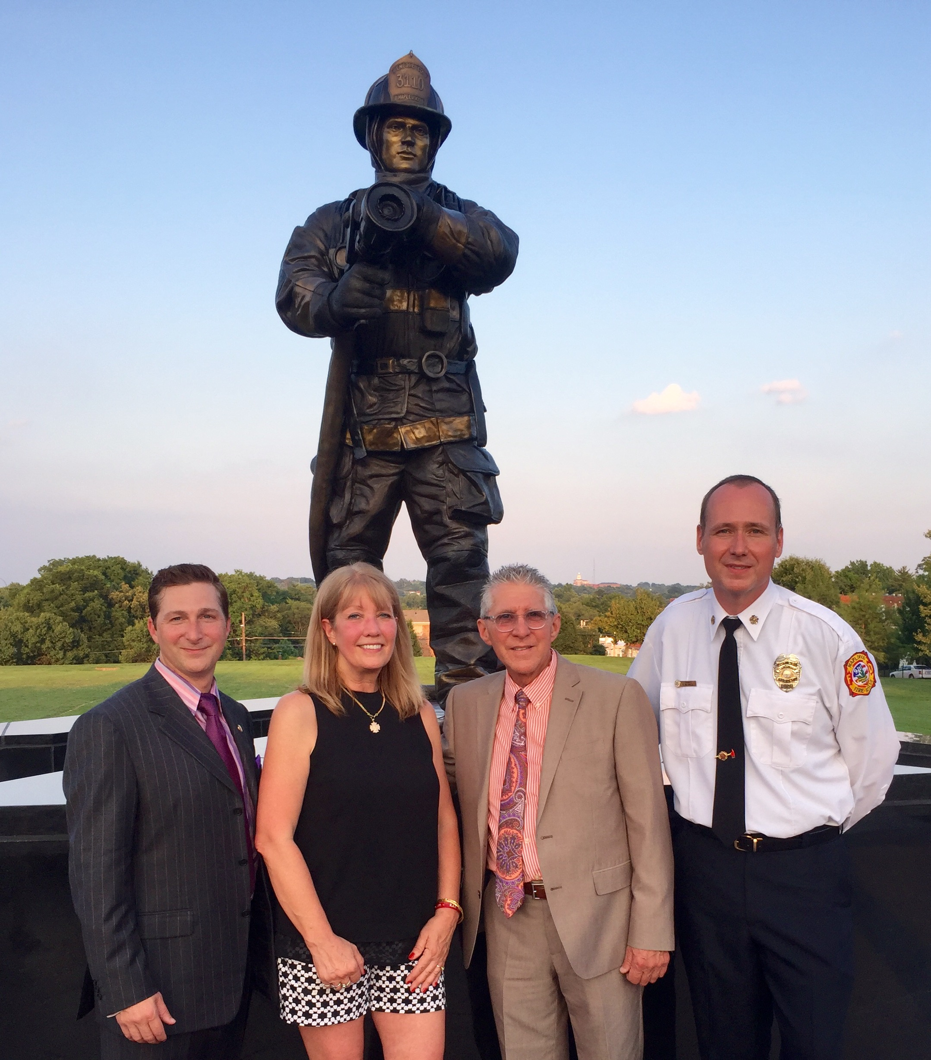 Pictured, left to right, Firefighter Artist Robert Daus Jr, Ryans mother Jackie Hummert, Firefighter Artist Robert Daus Sr. and Maplewood Fire Chief Terry Merrill.
