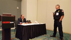 Brian Vickers, CEO of Vickers Consulting Inc., speaks with a student during a break in his class on grant writing at Firehouse Expo in Nashville.