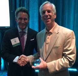 Mark Mordecai, director of business development at Globe, right, accepts the 2016 International Achievement Awards (IAA) Award of Excellence and Best in Category for Advanced Textiles.