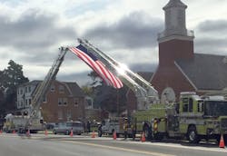 The Slatington ladder truck (left) was requested by a neighboring fire department to help fly an American flag at a funeral. The Slatington ladder truck (left) was requested by a neighboring fire department to help fly an American flag at a funeral.