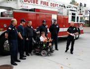 RIT Safety Solutions LLC of Twinsburg, OH, has donated an EZ-Don rescue harness to the Boise Fire Department. Receiving the gift with the firefighters is JoJo Tuinstra, 12, of Kuna, ID.