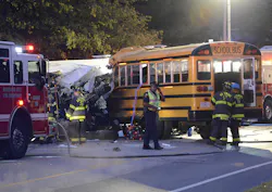 Firefighters and police look over the scene where commuter bus and school bus collided early Tuesday. Firefighters and police look over the scene where commuter bus and school bus collided early Tuesday.
