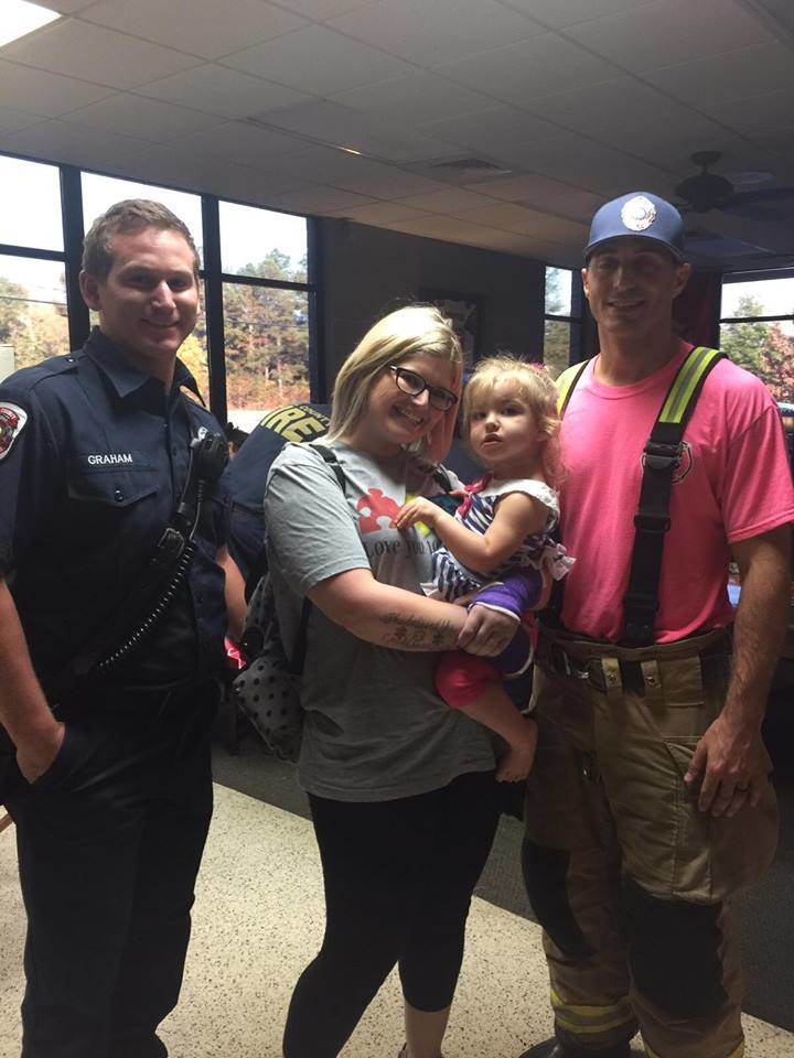 Summer Ginn and her two-year-old daughter Raelyn visit with Hall County firefighters after the crash.