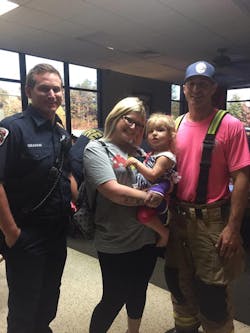 Summer Ginn and her two-year-old daughter Raelyn visit with Hall County firefighters after the crash. Summer Ginn and her two-year-old daughter Raelyn visit with Hall County firefighters after the crash.