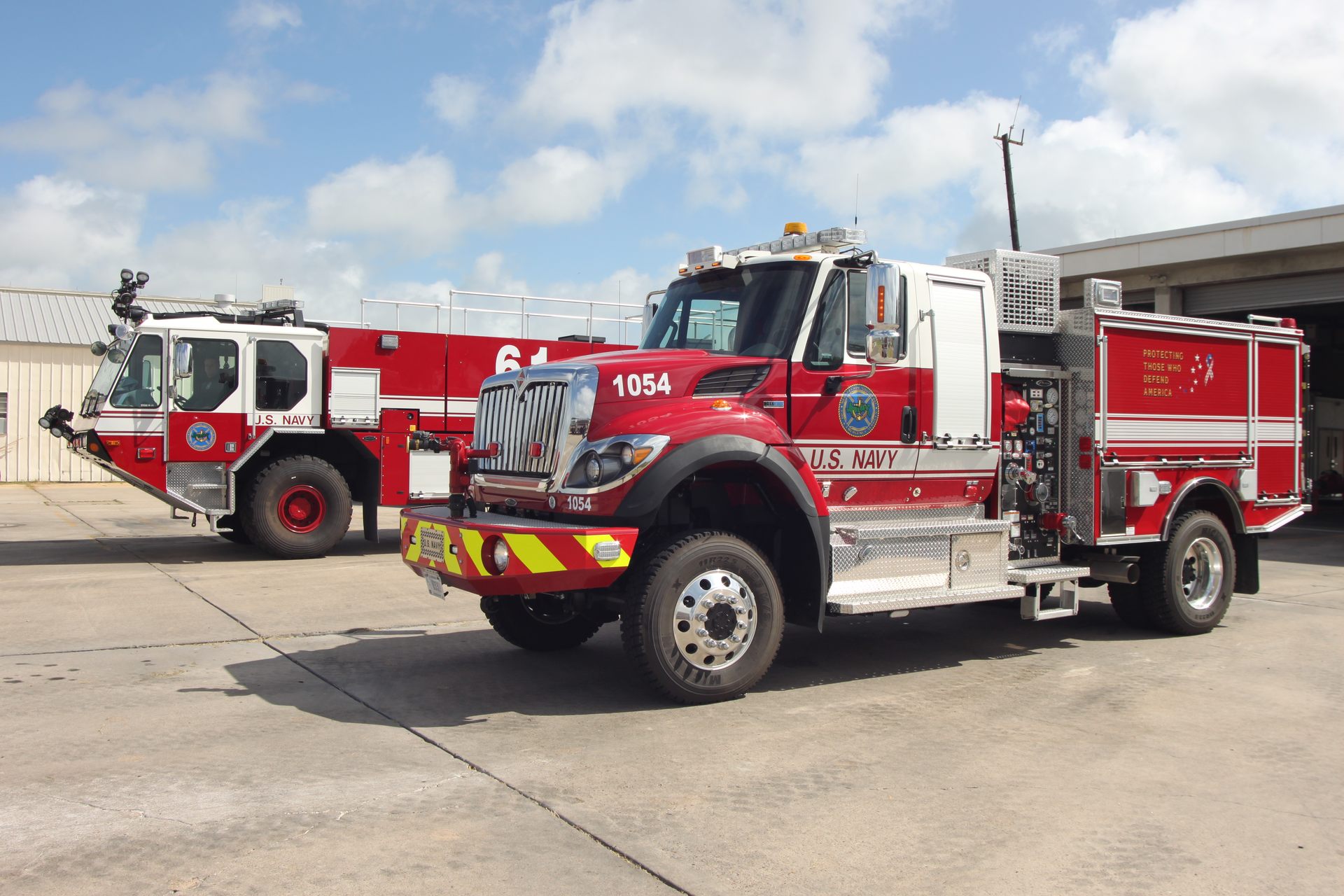 Dry agent quick response ARFF unit in the foreground and ARFF foam crash truck in the background.