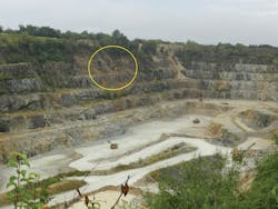 An overall photo of the vast quarry operation. The overturned dump truck is pictured in the yellow circle. Emergency vehicles can be seen lined along the south rim at the top left. The large quarry haul trucks are seen 350 feet down. An overall photo of the vast quarry operation. The overturned dump truck is pictured in the yellow circle. Emergency vehicles can be seen lined along the south rim at the top left. The large quarry haul trucks are seen 350 feet down.