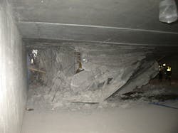 Photo 1. Rescuers will have to manipulate their way through the debris to access voids created by the collapse.
