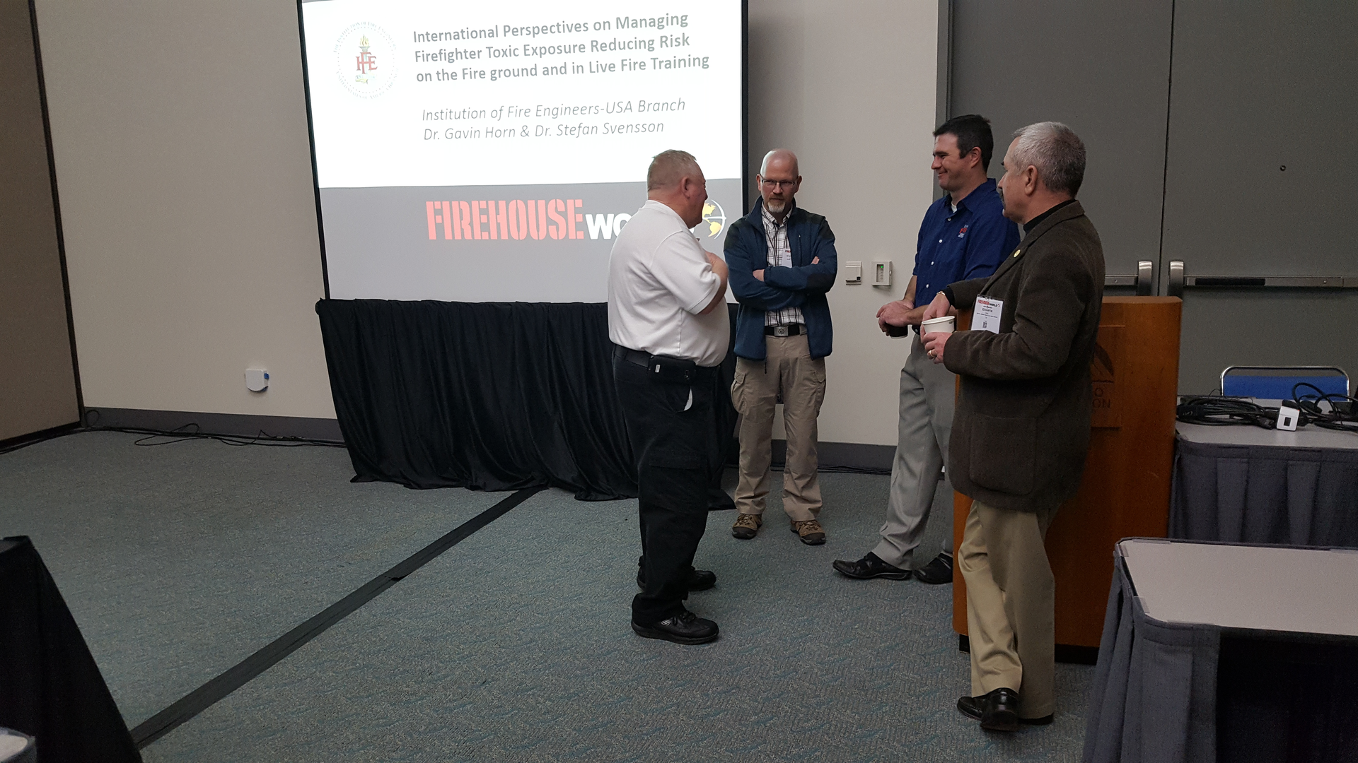 Gathering before a class on the international perspective on firefighter toxic exposures were, left to right Bruce Varner, a representative of The Institution of Fire Engineers, class presenter, Dr. Stefan Svensson, class presenter Dr. Gavin Horn and Ed Hardin, also of The Institution of Fire Engineers.