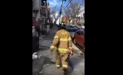 A witness captured video of the woman wearing a Jersey City firefighter&apos;s PPE and carrying a flashlight.