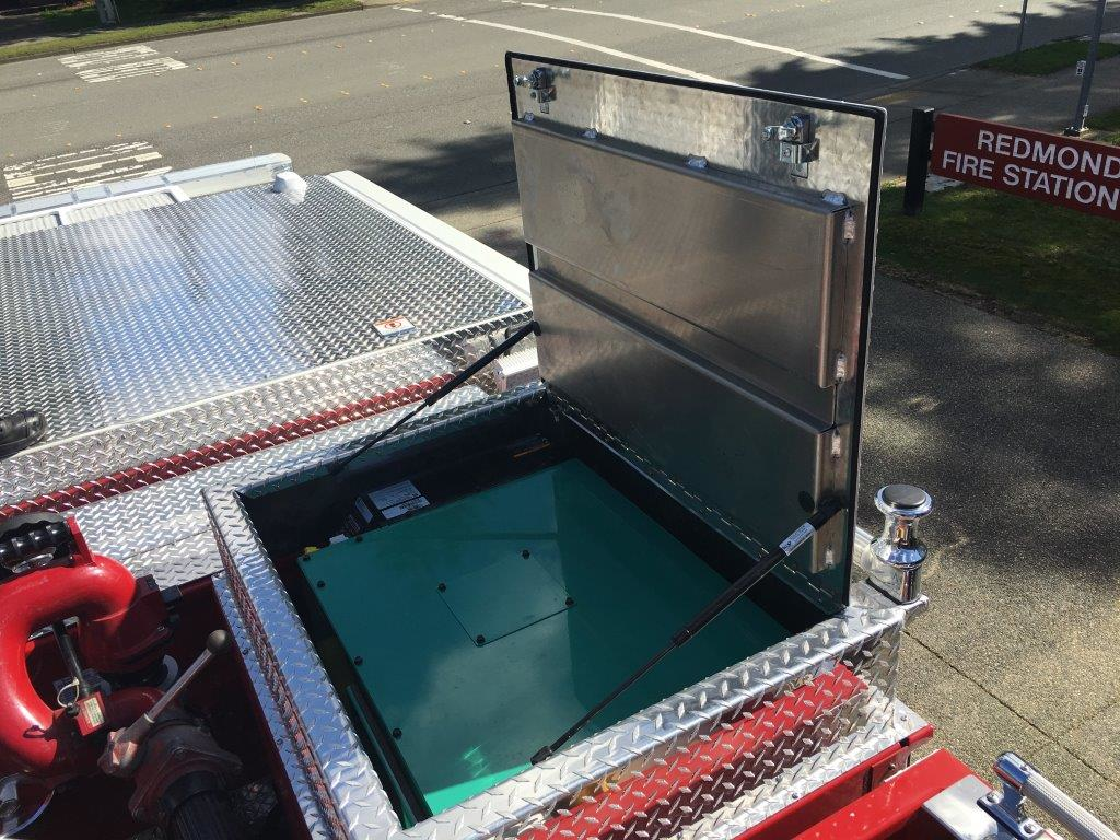 The idle-reduction unit, which is also called the Auxiliary Power Unit, often consists of a generator tucked in a compartment, usually above the pump house like this unit on Redmond, WA, Fire Department's new Pierce pumper.