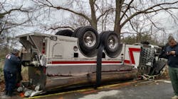 Officials examine the scene where a Dunkirk Fire Department tanker rolled over en route to a house fire. Officials examine the scene where a Dunkirk Fire Department tanker rolled over en route to a house fire.