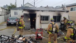San Diego firefighters remain on scene after containing a house fire in March.