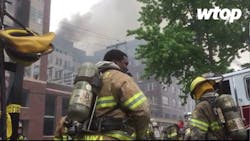 Firefighters work to contain a five-alarm fire at a construction site in College Park, MD.