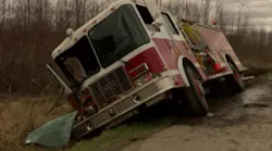 A fire truck sits in a ditch after a crash that injured two Vermont firefighters.