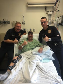 Polk County Battalion Chief Kevin Shireman, center, needed emergency surgery after the suspect in a vehicle wreck bit him twice. Polk County Battalion Chief Kevin Shireman, center, needed emergency surgery after the suspect in a vehicle wreck bit him twice.