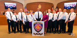 San Antonio Fire Chief Charles Hood, center, is flanked by City Manager Sheryl Sculley on his left and Mayor Ivy R. Taylor on his right along with fire department staff members as they accept the Class 1 designation award to the city's fire department by ISO.