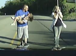 Firefighter Ryan Ciampoli is caught by his dashcam as he rushes to the aid of a four-year-old girl who fell from the rear of a school bus.