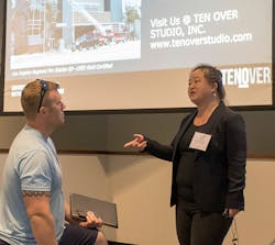 Candice Wong talks with a Station Design Conference attendee following her session on green and LEED fire stations.