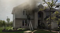 The initial size-up indicated smoke showing from the roof and attic soffits; however, the fire was ultimately found in multiple locations.