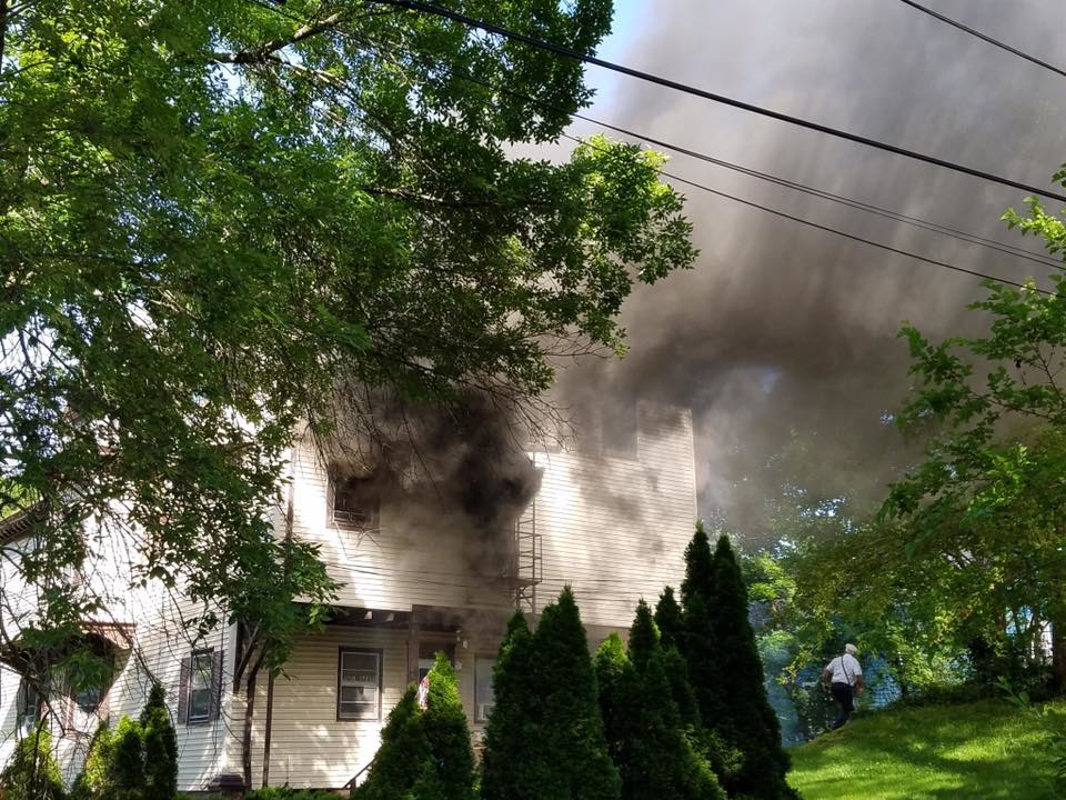 Poughkeepsie firefighters battled a blaze at a three-story apartment structure last Wednesday and rescued a badly burned woman with the help of a thermal imaging camera.