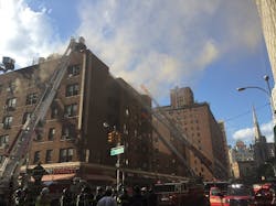 New York City firefighters tackle a five-alarm apartment building fire in Manhattan&apos;s East Village on Wednesday night.