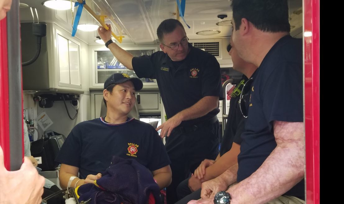 Dallas Fire Rescue paramedic William An, who was critically wounded in a shooting May 1 during a response call, smiles while talking to colleagues after being released from the hospital Wednesday.