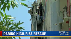 A Sarasota firefighter rappels down to rescue a construction worker who became trapped when the scaffolding he was on malfunctioned Monday.