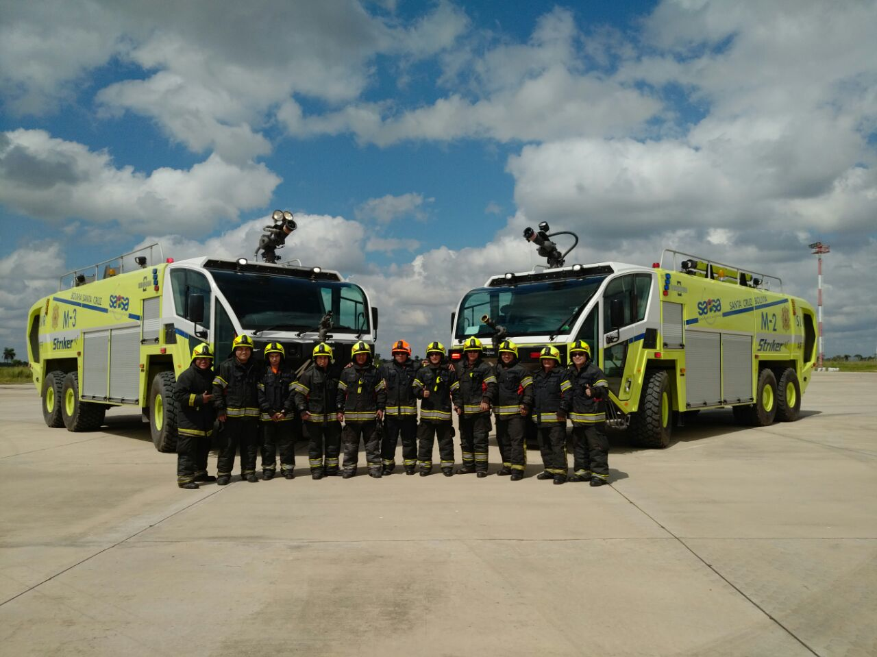 Oshkosh Airport Products is delivering three more Oshkosh&circledR; Striker&circledR; 6 X 6 aircraft rescue and fire fighting (ARFF) vehicles to airports administered and operated by Servicios Aeroportuarios Bolivianos S.A. (SABSA) for the country of Bolivia. Shown here are firefighters from Viru Viru International Airport in Santa Cruz alongside their matching pair of Striker ARFF vehicles.