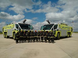 Oshkosh Airport Products is delivering three more Oshkosh&circledR; Striker&circledR; 6 X 6 aircraft rescue and fire fighting (ARFF) vehicles to airports administered and operated by Servicios Aeroportuarios Bolivianos S.A. (SABSA) for the country of Bolivia. Shown here are firefighters from Viru Viru International Airport in Santa Cruz alongside their matching pair of Striker ARFF vehicles.